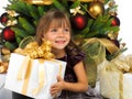 Pretty girl with present near the Christmas tree Royalty Free Stock Photo