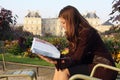 Pretty girl reading magazine in Luxembourg garden Royalty Free Stock Photo