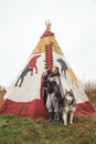 Cute adult girl owner with her malamute gray big dog in the Injun camping