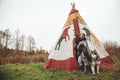 Cute adult girl owner with her malamute gray big dog in the Injun camping