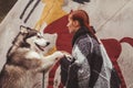 Cute adult girl owner with her malamute gray big dog in the Injun camping