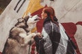 Cute adult girl owner with her malamute gray big dog in the Injun camping