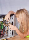 Pretty girl repairing computer