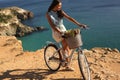 Pretty girl riding a bicycle along the sea coast Royalty Free Stock Photo