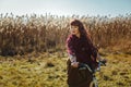 Pretty girl riding bicycle in field