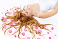 Pretty girl with rose petals in her hair Royalty Free Stock Photo