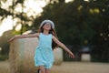 A pretty girl runs across a field with her arms spread wide Royalty Free Stock Photo