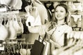 Pretty girl shopper examining bras in shop