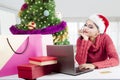 Pretty girl shopping online with a laptop Royalty Free Stock Photo