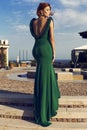 Pretty girl with short red hair in luxurious green dress