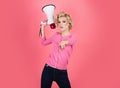 Pretty girl shouting into megaphone isolated, copy space. Idea for marketing or sales banner.