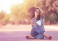 Pretty girl sitting on the floor with moving hair