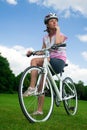 Pretty girl sitting on her bicycle Royalty Free Stock Photo