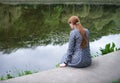 Pretty girl sitting at the lake