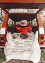 Pretty girl is sitting in the trunk of a red retro minivan. View from the back. Blanket and pillows in Scandinavian style on her Royalty Free Stock Photo