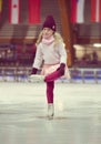Pretty girl skates in a red cap, warm gloves and sweater Royalty Free Stock Photo