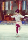 Pretty girl skates in a red cap, warm gloves and sweater Royalty Free Stock Photo