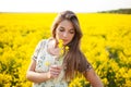 Pretty girl smelling yellow wildflower