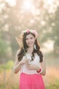 Pretty girl smiles in spring flower grass field Royalty Free Stock Photo