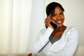 Pretty girl smiling at you while speaking on phone Royalty Free Stock Photo