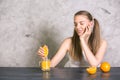 Pretty girl squeezing orange Royalty Free Stock Photo