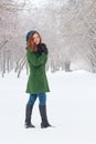 Pretty girl stands outdoor at winter day in park Royalty Free Stock Photo