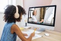 Biracial schoolgirl studying with video online lesson at home Royalty Free Stock Photo