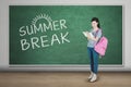 Pretty girl with summer break word in class Royalty Free Stock Photo