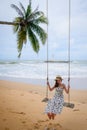 Pretty girl on swing with backgound of Nang Thong Beach in Khao lak lighthouse Royalty Free Stock Photo