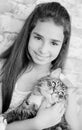 Pretty girl teenager 10-11 years holding a cat Royalty Free Stock Photo