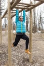 Pretty girl training on monkey bars obstacle Royalty Free Stock Photo