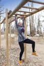 Pretty girl training on monkey bars obstacle Royalty Free Stock Photo