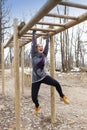 Pretty girl training on monkey bars obstacle Royalty Free Stock Photo