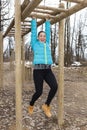 Pretty girl training on monkey bars obstacle Royalty Free Stock Photo