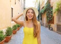 Pretty girl in Trastevere, Rome. Beautiful fashion woman with yellow dress and hat walks through the streets of Rome, Italy Royalty Free Stock Photo