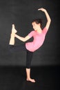 Pretty girl trying to exercise yoga - dancer pose Royalty Free Stock Photo