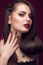 Pretty girl with unusual hairstyle, bright makeup, red lips and manicure design. Beauty face. Art nails. Royalty Free Stock Photo