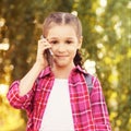 Pretty girl using cellphone. Holding mobile phone. Smiling beauty portrait Royalty Free Stock Photo