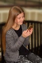 Pretty girl using her cell phone. Royalty Free Stock Photo