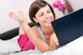 Pretty Girl Using her Laptop in Bed Royalty Free Stock Photo