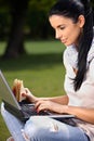 Pretty girl using laptop in park Royalty Free Stock Photo