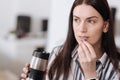 Pretty girl using thermos to wash down tablets Royalty Free Stock Photo