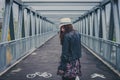 Pretty girl walking away on a bridge Royalty Free Stock Photo