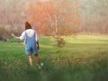 Pretty girl walking and dancing through a green field, summer outdoor Royalty Free Stock Photo