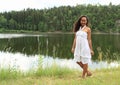 Pretty girl walking by water Royalty Free Stock Photo