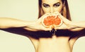 Pretty girl squeezing juice from fresh orange grapefruit Royalty Free Stock Photo