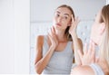 Pretty girl, woman touching her neck and head while looking in the mirror, beauty concept,wrinkles Royalty Free Stock Photo