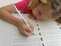 Pretty girl writening math homework Royalty Free Stock Photo