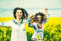 Pretty girls outdoor walking in the field in embroidery shirts Royalty Free Stock Photo