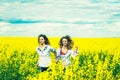 Pretty girls outdoor walking in the field in embroidery shirts Royalty Free Stock Photo